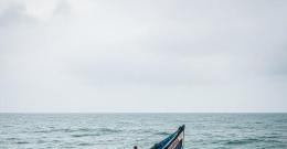 An Image created by AI depicting a boat capsize in the Ocean.